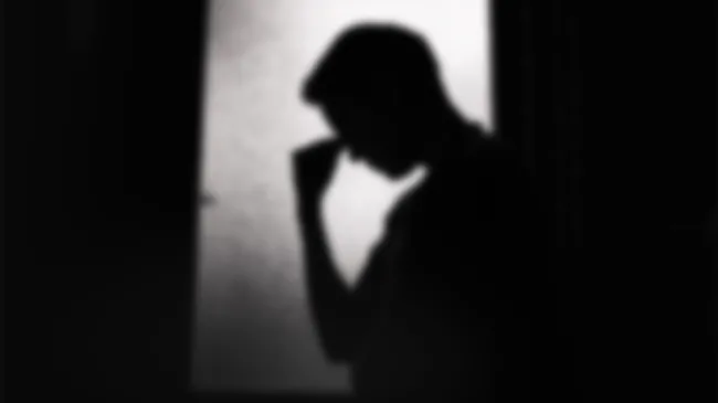 A man bows his head in despair
